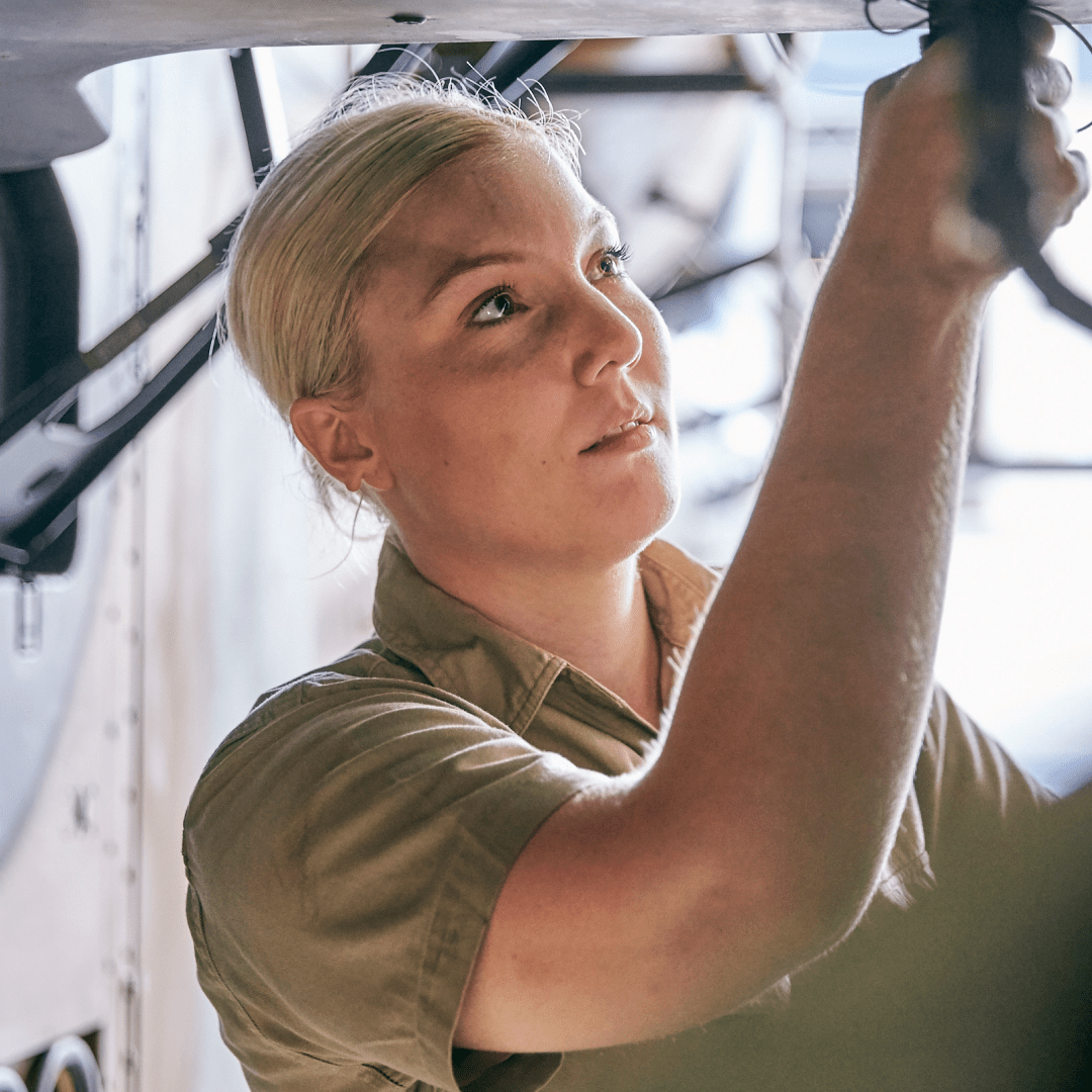 Aircraft Technician Amber works on a plane.
