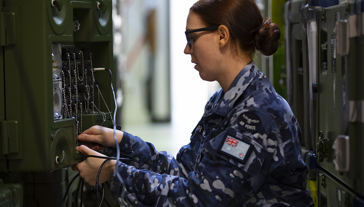 A member of the Air Force is positioned near a communication device.