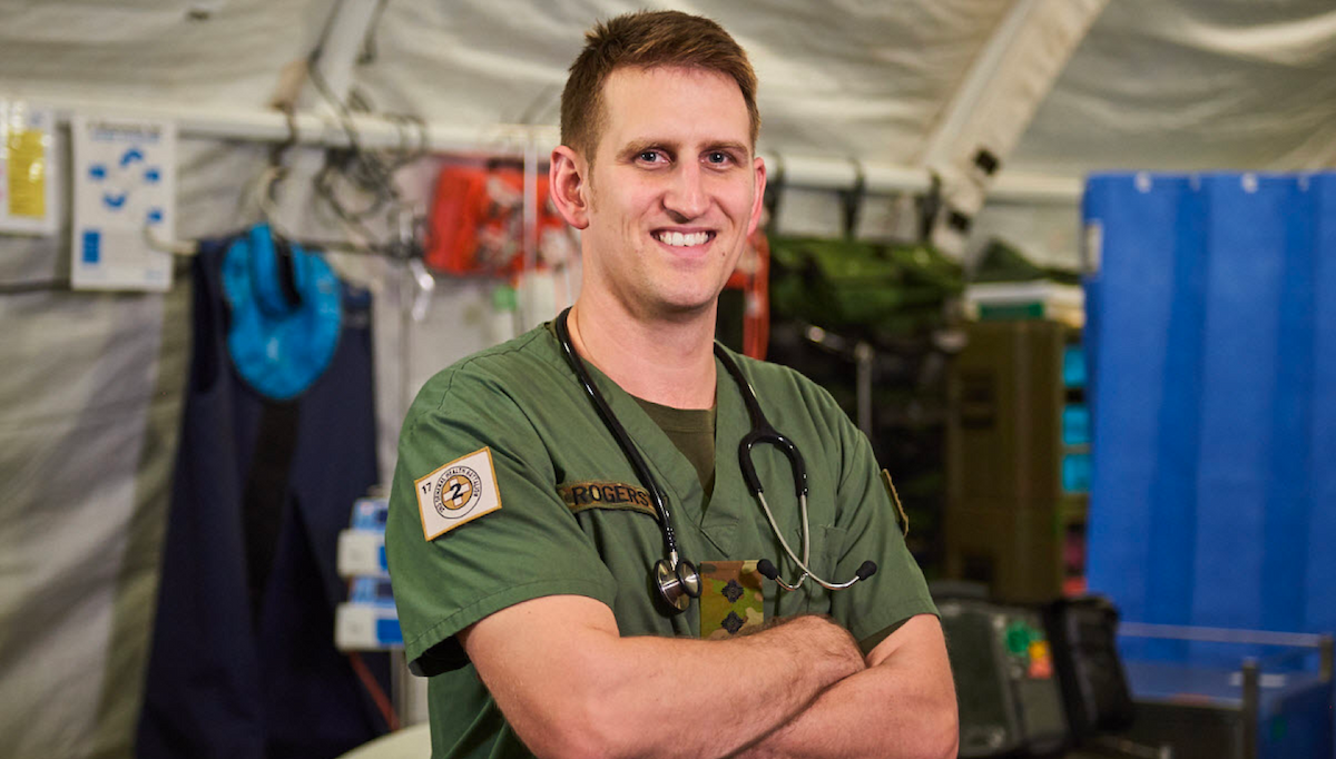 An Army medic smiles at camera.